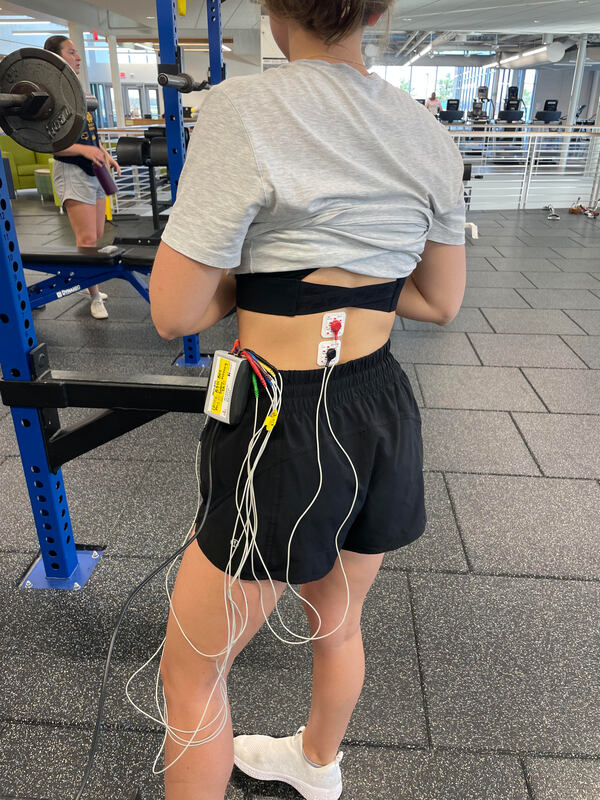 Two EMG leads on a woman's lower back